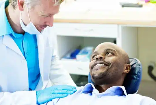 A happy conversation between a patient and a dentist