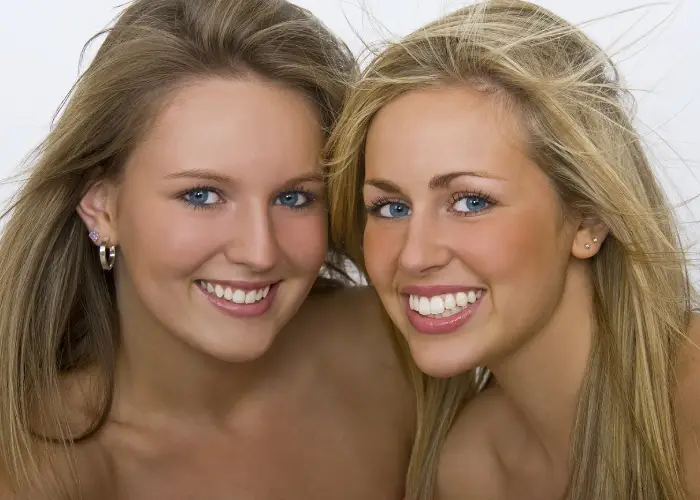 Two women smiling with perfect teeth after visiting Dentist in Houston, TX